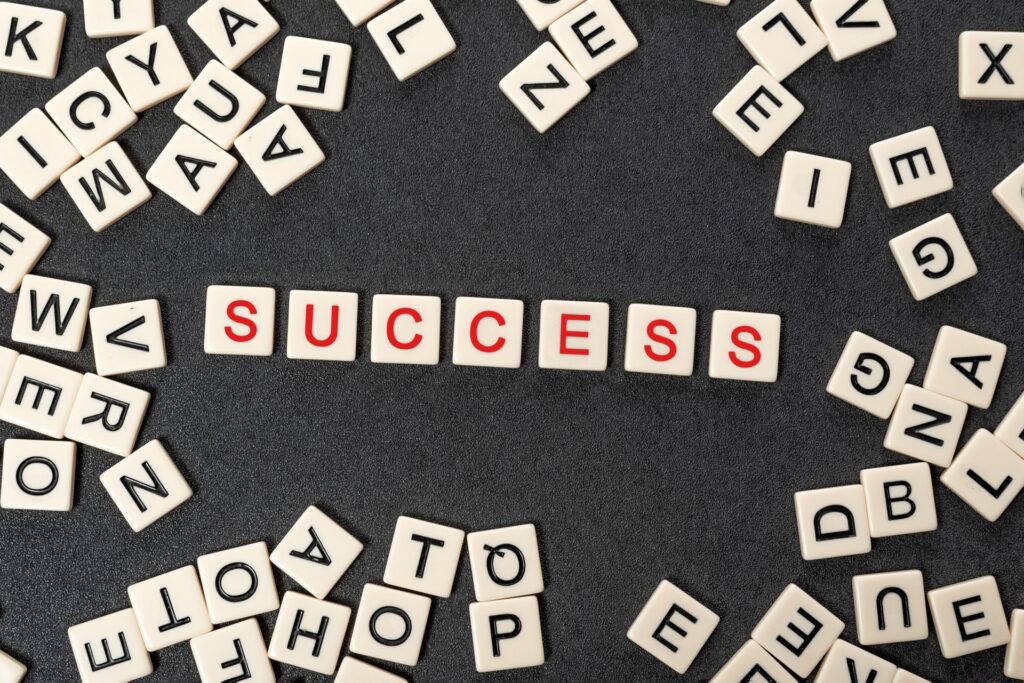 Success word spelled with scrabble tiles